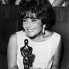 Elizabeth Taylor poses in 1961 with the Oscar she won for her role as a call girl in 